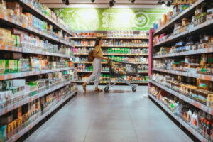woman with shopping between store shelf